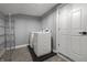 Functional laundry room with modern washer and dryer, plus shelving for storage at 629 N Keystone Ave, Indianapolis, IN 46201