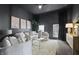 Living room with a comfortable white sofa, glass coffee table, and dark-colored walls at 629 N Keystone Ave, Indianapolis, IN 46201