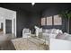Spacious living room featuring stylish decor, a comfortable sofa, and a glass coffee table at 629 N Keystone Ave, Indianapolis, IN 46201