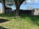 Spacious backyard view with mature trees, storage sheds, and a black wooden fence at 630 Johnson Rd, Mooresville, IN 46158