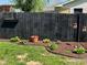 View of a well maintained backyard with a wood fence and manicured flower beds at 630 Johnson Rd, Mooresville, IN 46158