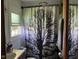Bathroom view featuring a vanity, toilet, and shower/tub combo with tree-themed shower curtain at 630 Johnson Rd, Mooresville, IN 46158