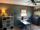 This home office offers a modern design with wood flooring and a dark accent wall at 630 Johnson Rd, Mooresville, IN 46158