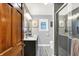 Bathroom with framed mirrors, granite countertops, hardwood floors and glass shower at 6440 Saint Joe Dr, Indianapolis, IN 46217