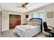 Bedroom with a ceiling fan, hardwood floors and a wooden closet door at 6440 Saint Joe Dr, Indianapolis, IN 46217