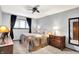 Cozy bedroom with carpet, neutral color palette, dresser, and ceiling fan with light at 6440 Saint Joe Dr, Indianapolis, IN 46217