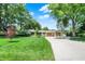 Charming single-story home with a well-maintained lawn, mature trees, and an attached two-car garage at 6440 Saint Joe Dr, Indianapolis, IN 46217