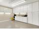 This garage features storage cabinets, overhead lighting, and painted walls and floors at 6440 Saint Joe Dr, Indianapolis, IN 46217