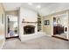 Living room featuring a white brick fireplace, built-in shelves and hardwood floors at 6440 Saint Joe Dr, Indianapolis, IN 46217