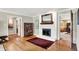 Elegant living room with a fireplace, hardwood floors, and an open doorway at 6440 Saint Joe Dr, Indianapolis, IN 46217