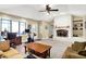 Spacious living room features a brick fireplace, beamed ceiling, and access to a sunroom at 6440 Saint Joe Dr, Indianapolis, IN 46217