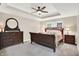 This is a traditionally furnished main bedroom with a ceiling fan and a tray ceiling at 6440 Saint Joe Dr, Indianapolis, IN 46217
