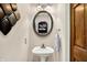 A well-decorated powder room with a pedestal sink and decorative lighting at 6440 Saint Joe Dr, Indianapolis, IN 46217