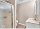 Bathroom featuring walk-in shower, tile, and white single vanity at 65 Palomino Ct, Zionsville, IN 46077