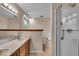Bathroom featuring tiled floors, wooden cabinets, and glass shower at 65 Palomino Ct, Zionsville, IN 46077