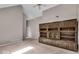 A spacious carpeted bedroom with a ceiling fan and a large built-in wooden bookshelf at 65 Palomino Ct, Zionsville, IN 46077