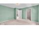 Green bedroom with carpet and two doorways leading to other rooms and a closet at 65 Palomino Ct, Zionsville, IN 46077