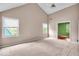 Large carpeted bedroom with many windows to let in natural light and vaulted ceilings at 65 Palomino Ct, Zionsville, IN 46077