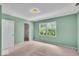 Green bedroom featuring a closet and a window with a view of lush greenery at 65 Palomino Ct, Zionsville, IN 46077