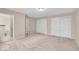 Bright bedroom features neutral paint, carpet, and two large closets at 65 Palomino Ct, Zionsville, IN 46077
