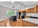 Bright eat-in kitchen features stainless steel appliances, wooden cabinets, island, and hardwood floors at 65 Palomino Ct, Zionsville, IN 46077