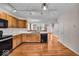 Well lit eat-in kitchen with wooden cabinets and view into the open concept dining and living area at 65 Palomino Ct, Zionsville, IN 46077