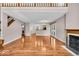 Spacious living area featuring gleaming hardwood floors, a fireplace, staircase and open access to the kitchen at 65 Palomino Ct, Zionsville, IN 46077