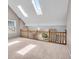 Well lit loft with carpet, wooden railing, and two skylights at 65 Palomino Ct, Zionsville, IN 46077