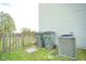 Backyard featuring vinyl siding and a wooden fence. Features AC unit and trash cans at 6634 Frankenberger Dr, Indianapolis, IN 46237