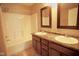 Bathroom with double sinks, vanity, and tub with shower at 6634 Frankenberger Dr, Indianapolis, IN 46237