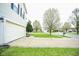 Wide driveway leading to a two-car garage, with a view of the tree-lined neighborhood at 6634 Frankenberger Dr, Indianapolis, IN 46237