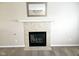 Close up of fireplace with tile surround, decorative mantel, and a dark firebox at 6634 Frankenberger Dr, Indianapolis, IN 46237