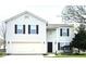 Traditional two-story home featuring white siding, black shutters, and an attached two-car garage at 6634 Frankenberger Dr, Indianapolis, IN 46237