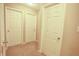 Hallway with neutral carpet and multiple doors leading to other rooms at 6634 Frankenberger Dr, Indianapolis, IN 46237