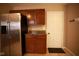 Galley kitchen featuring stainless steel refrigerator and wood cabinets at 6634 Frankenberger Dr, Indianapolis, IN 46237