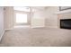Spacious living room with neutral carpet, fireplace, and ample natural light at 6634 Frankenberger Dr, Indianapolis, IN 46237