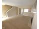 A spacious living room with carpet, stairs, a fireplace, and access to multiple rooms at 6634 Frankenberger Dr, Indianapolis, IN 46237