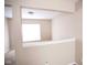 Bright loft area featuring neutral walls, carpet flooring and an open view to a window at 6634 Frankenberger Dr, Indianapolis, IN 46237