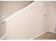 Neutral staircase with white railing and trim, blending seamlessly with the home's aesthetic at 6634 Frankenberger Dr, Indianapolis, IN 46237