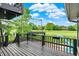 View from the black deck overlooking a spacious backyard with playground and extensive green space at 676 La Placita St, Greenwood, IN 46143