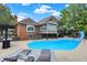 Back of the home featuring an in-ground pool, lounge chairs, and covered patio at 676 La Placita St, Greenwood, IN 46143