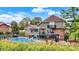 Back of the home featuring an in-ground pool and covered patio at 676 La Placita St, Greenwood, IN 46143
