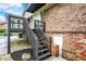 Multi-level backyard showcasing a brick exterior, black wooden stairs, and a walkout basement at 676 La Placita St, Greenwood, IN 46143