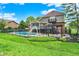 Exterior of house with pool, pergola, grassy yard, and fencing at 676 La Placita St, Greenwood, IN 46143