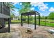 Outdoor living with a pergola on a stone foundation and a stone water feature at 676 La Placita St, Greenwood, IN 46143