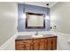 Bathroom vanity with marble countertop and a wooden frame mirror at 676 La Placita St, Greenwood, IN 46143