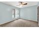 Light-filled bedroom featuring neutral carpet, a ceiling fan, and a bright window at 676 La Placita St, Greenwood, IN 46143