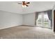 Large bedroom with gray paint and carpet includes a ceiling fan and exterior access to a balcony at 676 La Placita St, Greenwood, IN 46143