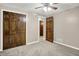 Bedroom with a ceiling fan, carpeted floor, and large wooden double-door closet at 676 La Placita St, Greenwood, IN 46143