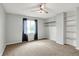 Neutral bedroom with carpet, ceiling fan, window with curtains, and closet shelves at 676 La Placita St, Greenwood, IN 46143